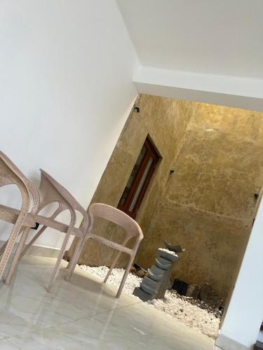 a room with two chairs and a window at Gateway terrace CMB Airport katunayake in Seeduwa