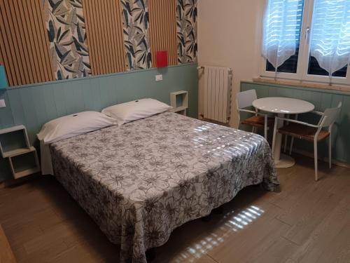 a bedroom with a bed and a table and chairs at Euro Hotel in Tirrenia