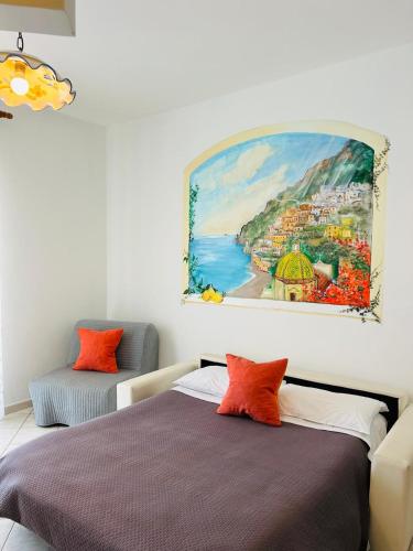 a bedroom with two beds and a painting on the wall at Locanda Costa D'Amalfi in Amalfi
