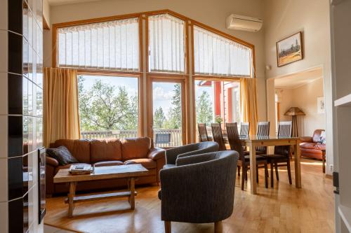 a living room with a couch and a table at Kiisa A&B two apartments with aurora room in Saariselka