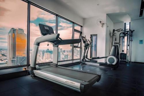 a gym with a view of a city at Hotel Serviced Condo Unique Infinity Pool with Mekong River View in Phnom Penh