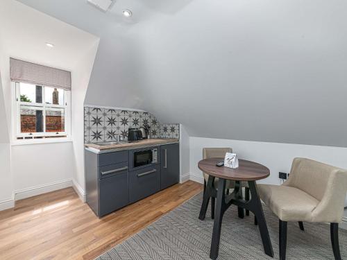 a kitchen with a table and a counter top at Mercure Salisbury White Hart Hotel & Apartments in Salisbury