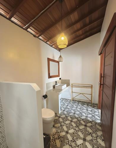 a bathroom with a toilet and a sink at Ginantary Cottages in Uluwatu