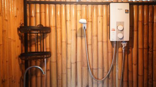 a room with a wall with wooden pipes at Rice Field Bungalows 