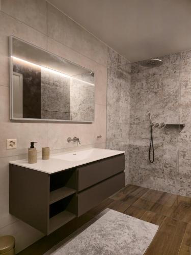 a bathroom with a sink and a mirror at Luxury Lake View Apartment Minusio by HolAp in Minusio