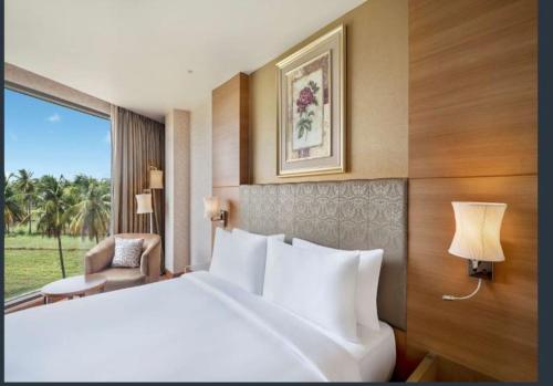 a hotel room with a large bed and a window at Radisson Salem in Salem