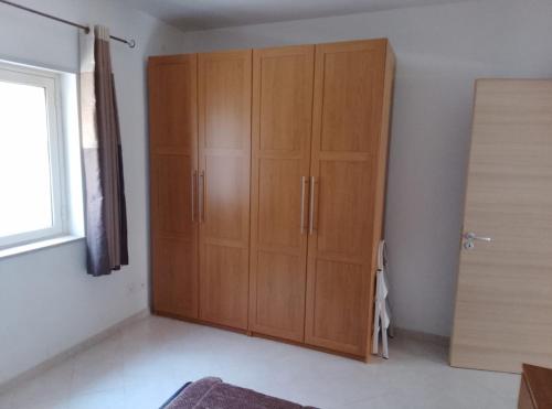 a large wooden cabinet in a room with a window at Sunshine calabria in Pizzo