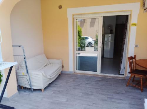 a living room with a white couch and a sliding glass door at Sunshine calabria in Pizzo