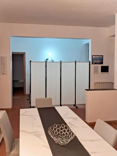 a room with a table and chairs and a large screen at Apt tra arte e natura ingresso indipendente in Florence
