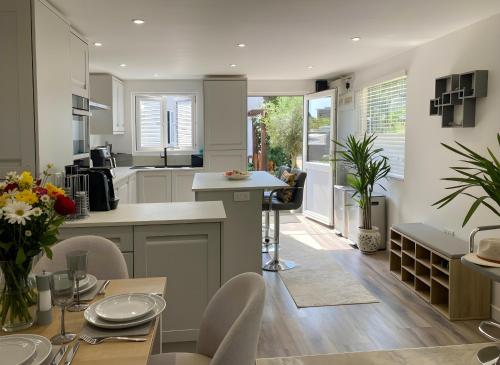 a kitchen and dining room with a table and chairs at Seahorse in Sark
