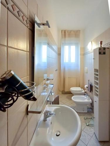 a white bathroom with a sink and a toilet at Apt tra arte e natura ingresso indipendente in Florence