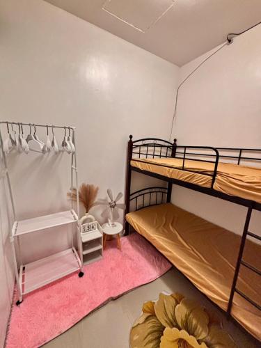 a bedroom with two bunk beds and a pink rug at Athena & Storm the Bay Nook in Victoria