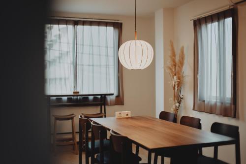 a dining room with a wooden table and chairs at Hazama in Tokyo
