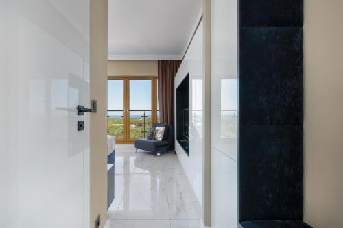a hallway with a door leading to a living room at Ambria Apartments Platan Tower in Świnoujście