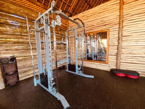 a gym with several tread machines in a wooden wall at Royal Mandarin Hotel & Resort in Pwani Mchangani