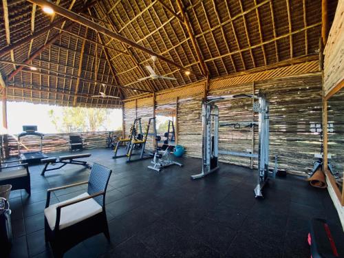 a gym with treadmills and exercise equipment in a building at Royal Mandarin Hotel & Resort in Pwani Mchangani