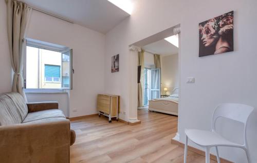 a living room with a couch and a bedroom at 3 Bedroom Amazing Apartment In Genova in Genova