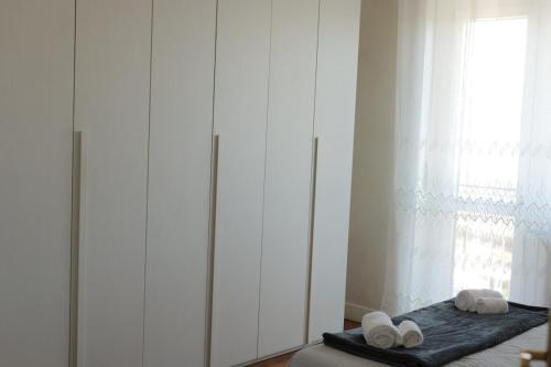 - une chambre avec des murs blancs et un lit avec des serviettes dans l'établissement Borgo Navile Apartment, à Turin