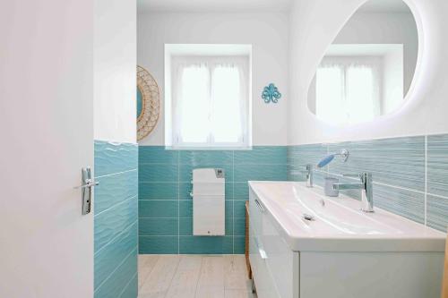 a bathroom with a sink and a mirror at Les coques bleues in Granville
