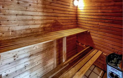 an empty wooden sauna with a bench in it at Awesome Home In Ringkøbing With Sauna in Søndervig