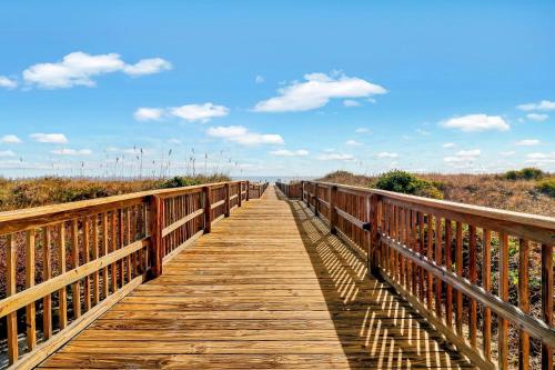 a wooden boardwalk leading to the ocean on a beach at Ov A-104 Ocean Villa - Ocean Front Resort Sleeps in Hilton Head Island