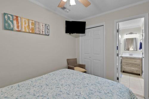 a bedroom with a bed and a flat screen tv at Ov A-104 Ocean Villa - Ocean Front Resort Sleeps in Hilton Head Island