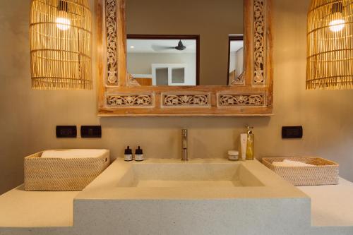 a bathroom with a large sink and a mirror at Karma Shana Residence in Lamai