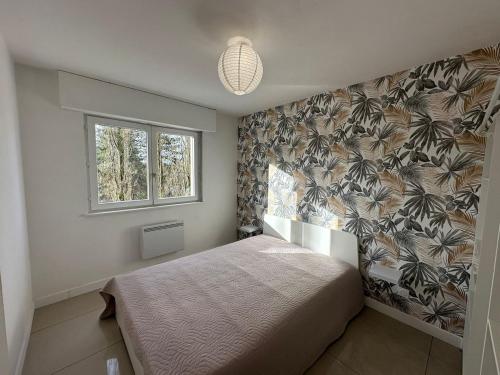 a bedroom with a bed and a window at Lumineux F2 avec balcon confort et praticité in Mulhouse