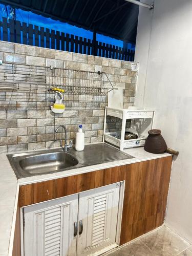 a kitchen with a sink and a brick wall at 350m to beach pool villa in Hua Hin