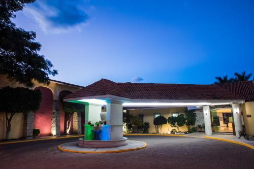 a building with a gazebo in the middle of a street at Fiesta Inn Oaxaca in Oaxaca City