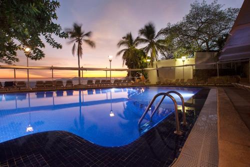 a swimming pool with a slide in a resort at Fiesta Americana Acapulco Villas in Acapulco