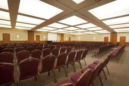 an empty room with rows of chairs and ceilings at Fiesta Americana Hermosillo in Hermosillo