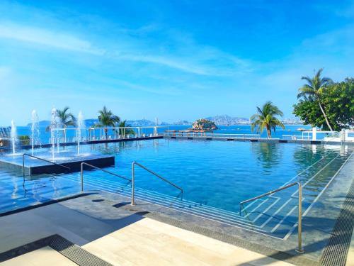 a swimming pool with a view of the water at Fiesta Americana Acapulco Villas in Acapulco