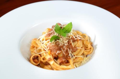 a bowl of spaghetti with meat sauce and a garnishment at Live Aqua Cancun - Adults Only - All-Inclusive in Cancún