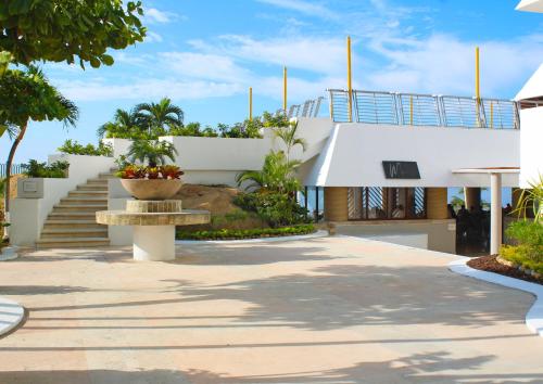 a white house with a staircase and a bench at Fiesta Americana Acapulco Villas in Acapulco
