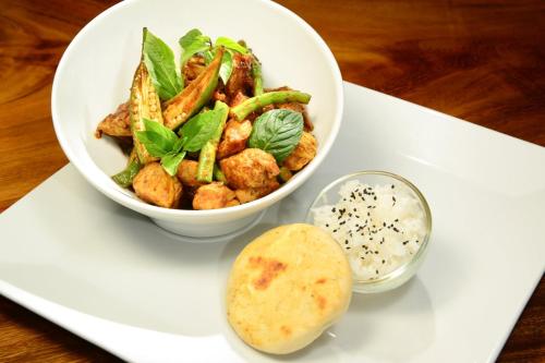 a white plate with a bowl of food on a table at Live Aqua Cancun - Adults Only - All-Inclusive in Cancún