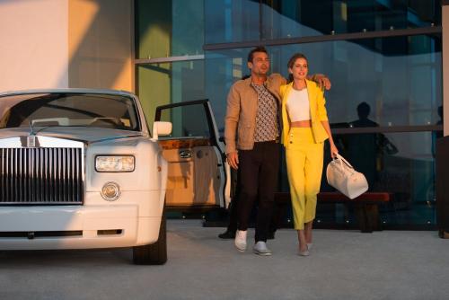 a man and a woman walking next to a white car at Live Aqua Cancun - Adults Only - All-Inclusive in Cancún