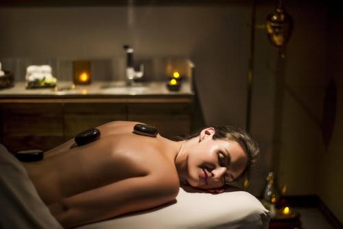 a woman laying on a bed in a room at Live Aqua Cancun - Adults Only - All-Inclusive in Cancún