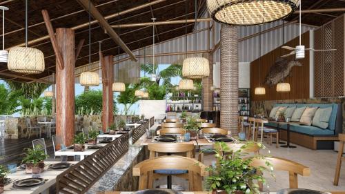 a restaurant with tables and chairs and potted plants at Live Aqua Cancun - Adults Only - All-Inclusive in Cancún