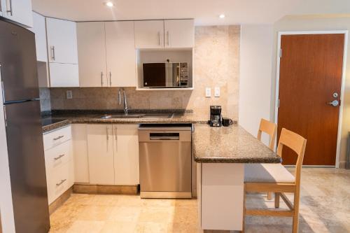 a kitchen with white cabinets and a counter top at Fiesta Americana Acapulco Villas in Acapulco