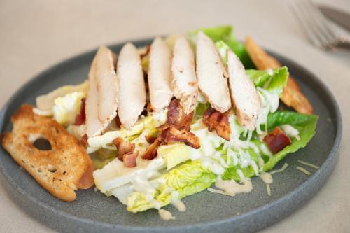a plate of food with a salad and meat at Fiesta Americana Acapulco Villas in Acapulco