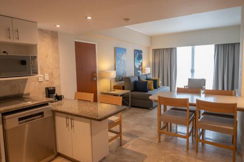 a living room with a kitchen and a dining room at Fiesta Americana Acapulco Villas in Acapulco