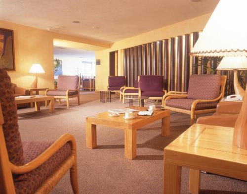 a hotel room with chairs and tables and a room at Fiesta Americana Reforma in Mexico City
