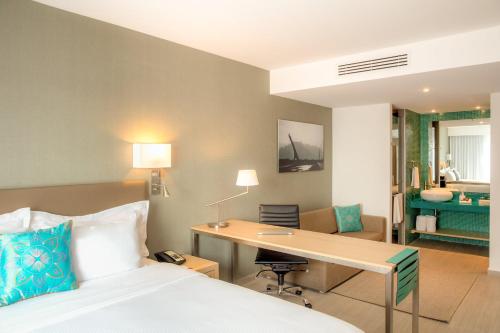 a hotel room with a bed and a desk at Fiesta Inn Monterrey la Fe in Monterrey
