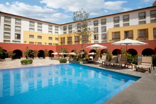 a large swimming pool in front of a hotel at Grand Fiesta Americana Queretaro in Querétaro