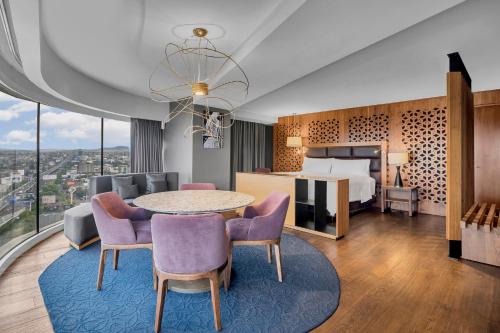 a hotel room with a bed and a table and chairs at Fiesta Americana Ciudad de México Satelite in Mexico City