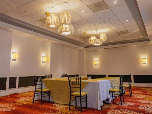a conference room with a table and chairs and chandeliers at Gamma Monterrey Gran Hotel Ancira in Monterrey