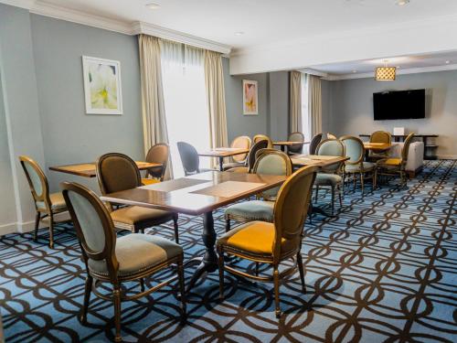 a conference room with tables and chairs and a flat screen tv at Gamma Monterrey Gran Hotel Ancira in Monterrey