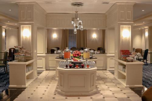 a salon with a table with flowers on it at Gamma Monterrey Gran Hotel Ancira in Monterrey