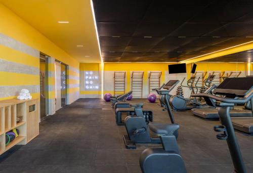 a gym with several treadmills and exercise machines at Fiesta Americana Condesa Cancun - All Inclusive in Cancún